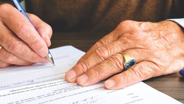 male hands signing document