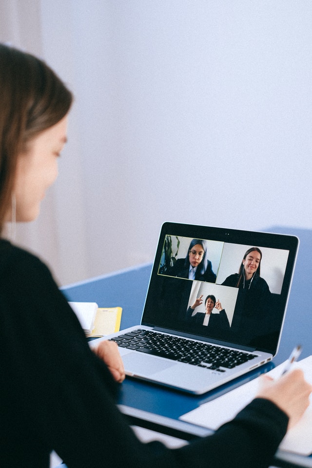 woman looking at laptop during video call